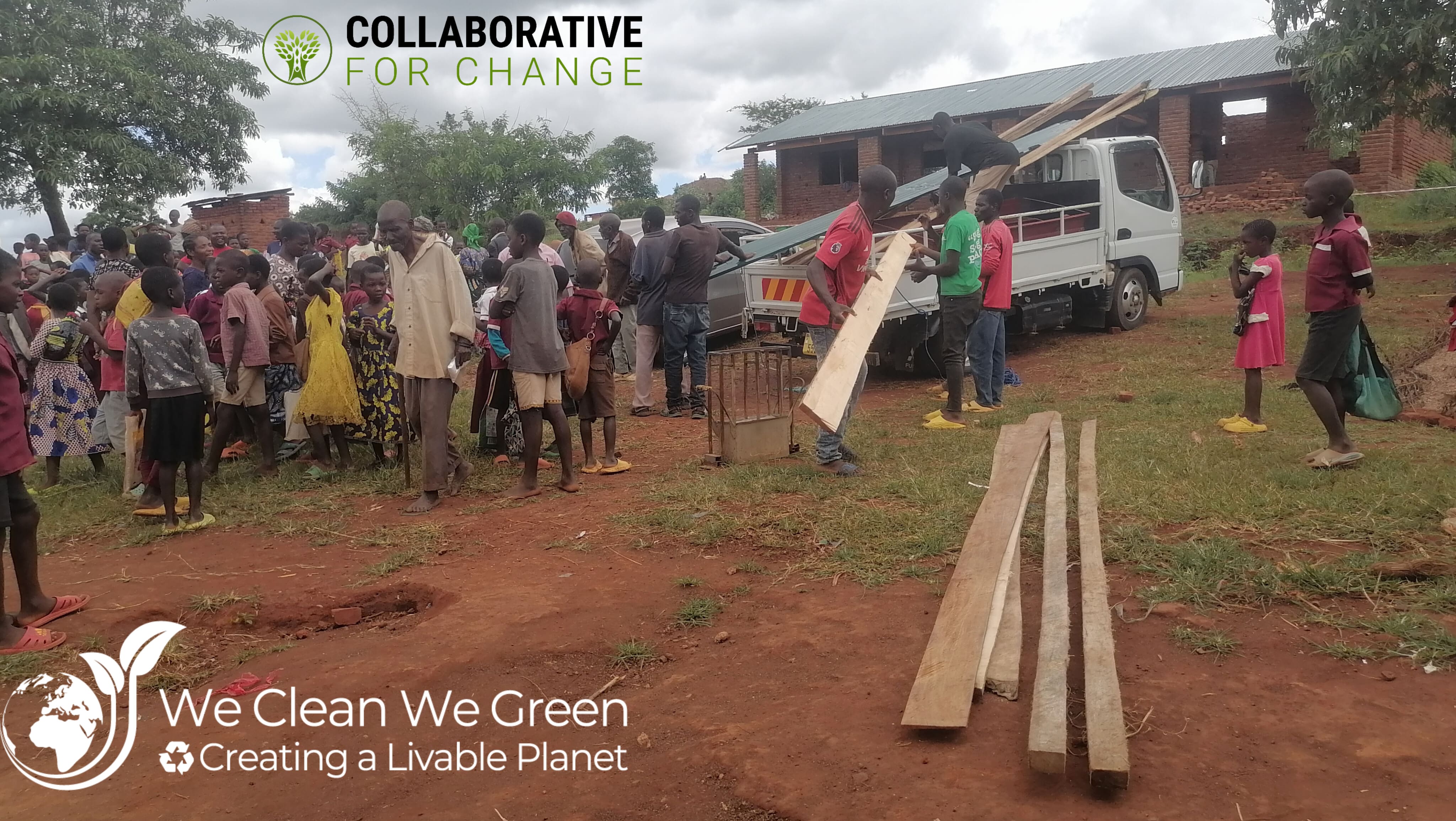Community members and building materials at the Nsonga school project