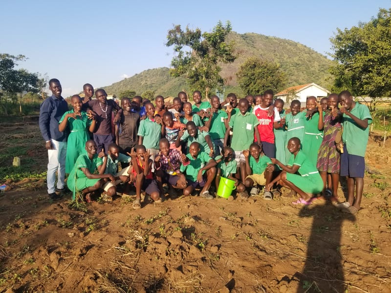 School-community group gathered outdoors with Rural Agroecology Network