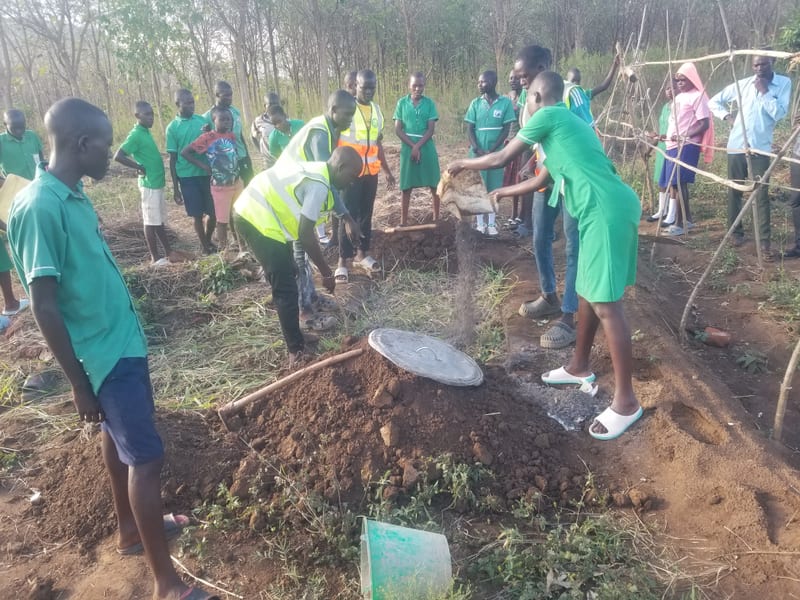 Participants preparing soil and plant material during a practical workshop